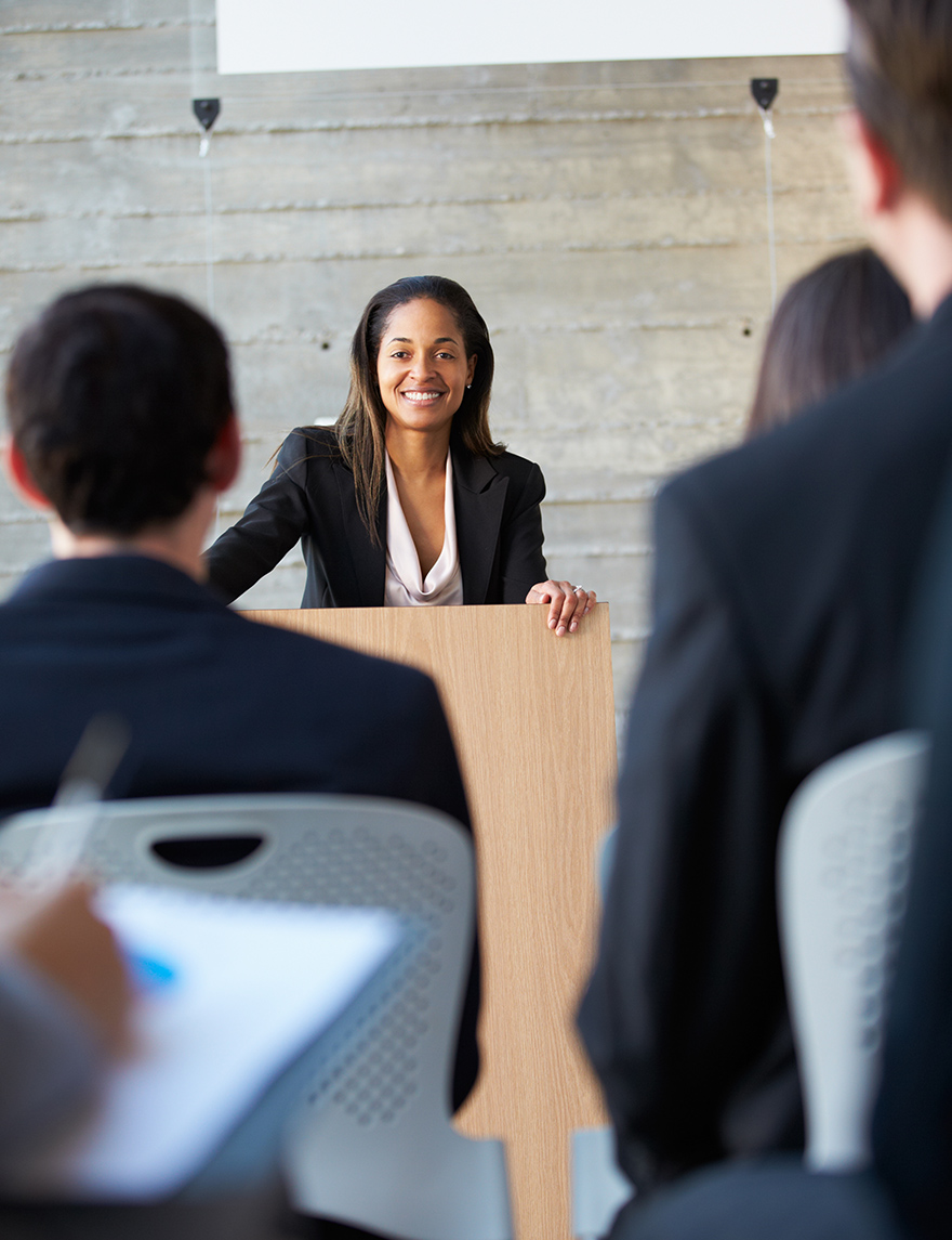 Businesswoman Delivering Presentation At Conference
